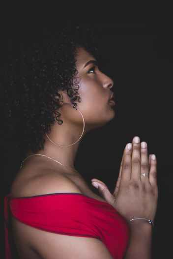 woman in red top praying