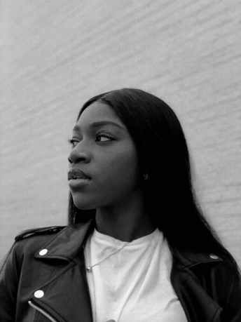 woman in white crew neck shirt and black jacket